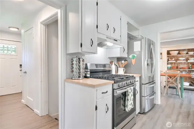 View of the front door entry and the kitchen,