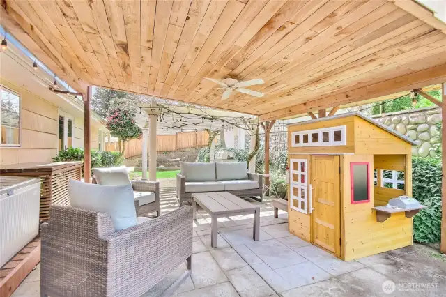 Covered patio with ceiling fan, perfect for summer entertaining.