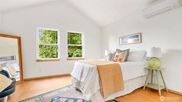 Vaulted ceilings in the primary bedroom and big windows let in so much light!