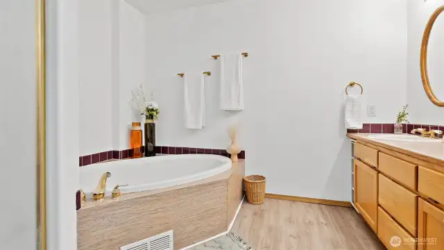 Ensuite primary bathroom with soaking tub.