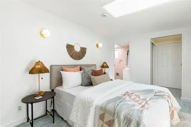 Another view of the primary bedroom showing the connection to the dedicated three-quarter bath.