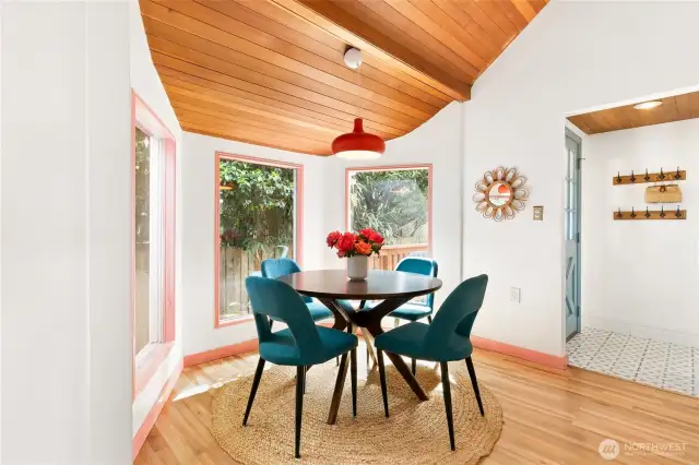 The dining room is surrounded by nature—morning coffee in the breakfast nook with flowers blooming and birds chirping is something the seller will miss dearly.