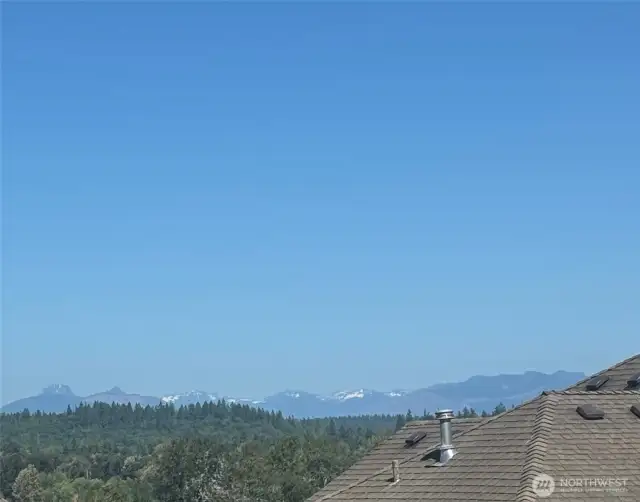 June 7 view from an iphone camera from the deck and E windows looking to the Cascade mountains with SNOW