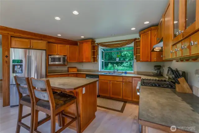Spacious kitchen with ample cabinets and counter space. Stainless steel appliances, including propane range.