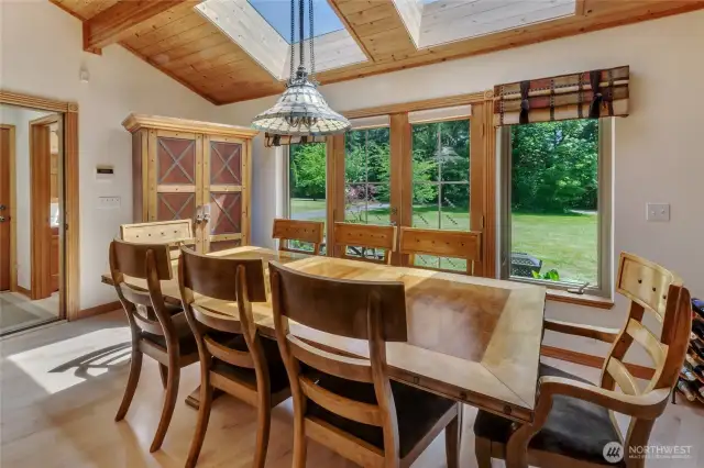 Large dining area with more windows and skylights, allowing for lots of natural light.