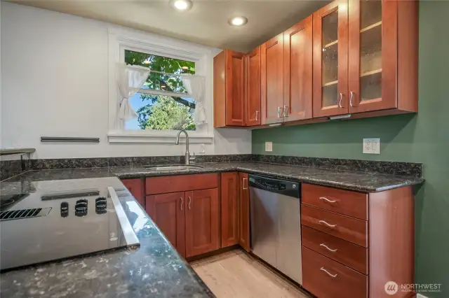 Kitchen is open to the great room. There's a pantry and a storage area nearby.