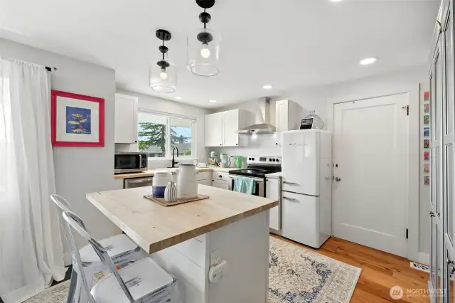 Open Kitchen with lots of light, butcher block kitchen island and new everything!