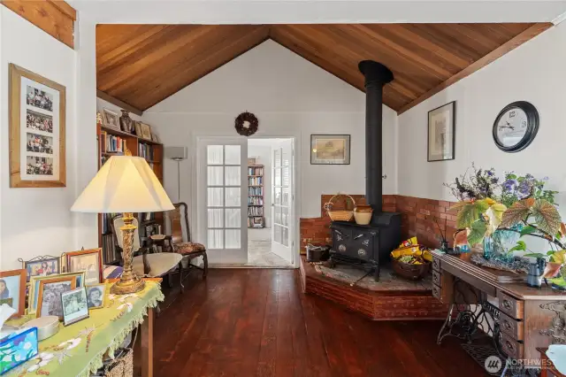 Vaulted ceilings leading to the main level primary bedroom through the french doors