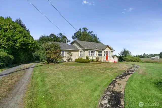 Long driveway and winding sidewalk to the front door