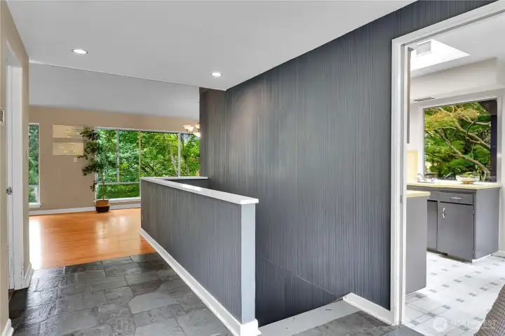 Slate entry, vaulted ceilings, hardwood floors in living and dining areas.  Stairs to lower level utility room.