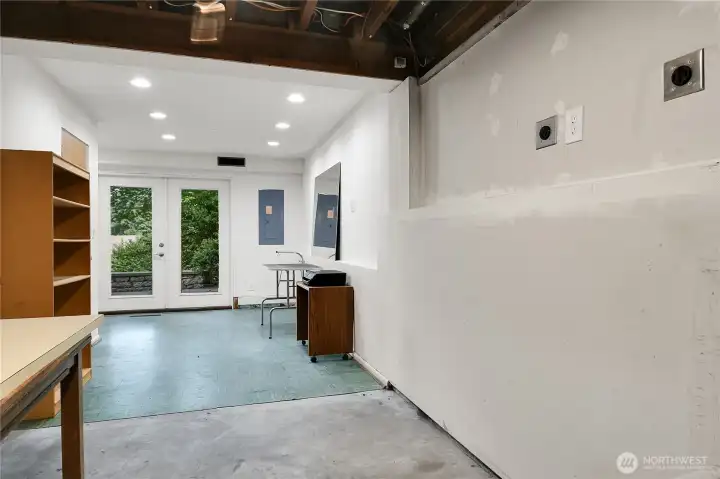 Utility room on lower level with double doors to patio and backyard.
