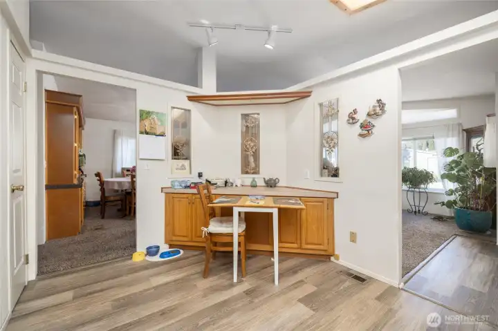 The breakfast nook in the kitchen, with the dining room visible to the left and living room on right.