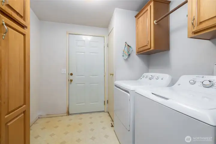 Big laundry room with storage and drying rack.