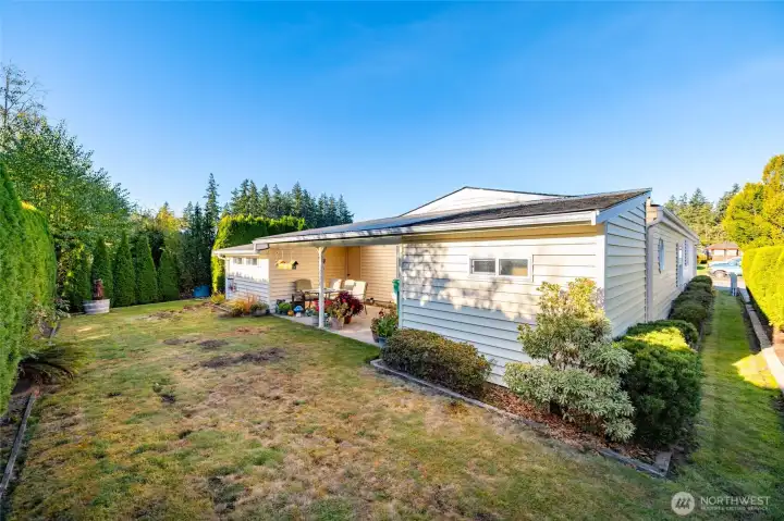 This cute back yard has a covered patio, two spacious storage sheds, and "just enough" grass for your pets or croquet.