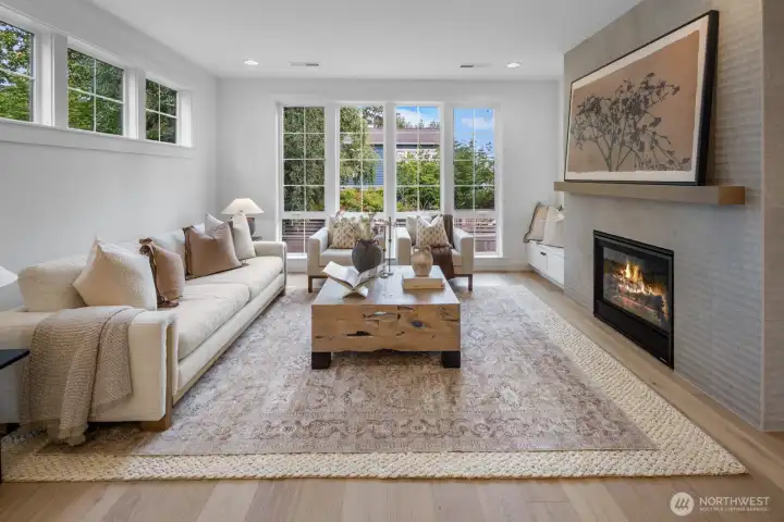 Sun-drenched living room with walls of windows, built-in seating, and thoughtful layout. Perfect balance of comfort and style, ideal for both entertaining and everyday living.