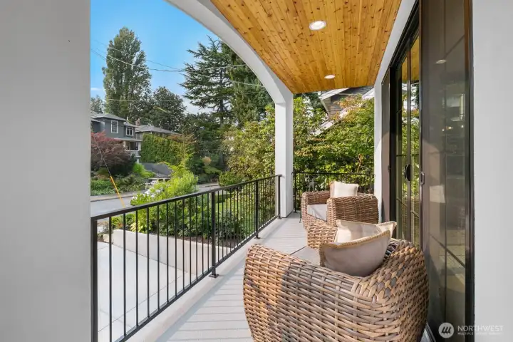 Covered outdoor living space with wood-clad ceiling, recessed lighting, and room for lounge seating. A serene setting to enjoy morning coffee or evening relaxation.