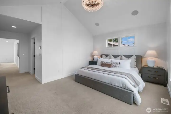 Spacious primary suite with vaulted ceilings and modern architectural details. Thoughtfully designed for comfort and relaxation.