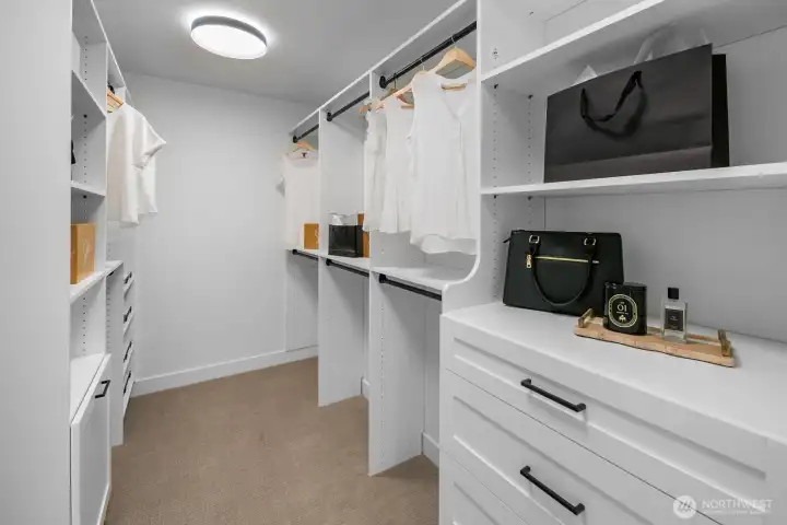 Custom closet system with dual hanging space, shelving, and drawer storage. Designed to maximize organization and style.