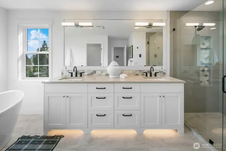 Luxurious primary bath with dual vanities, quartz counters, designer lighting, and full-height mirror. Elegant finishes create a spa-like retreat.