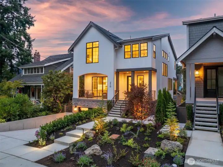 Striking modern architecture with timeless curb appeal. Professionally landscaped front yard with illuminated pathways, a welcoming covered entry, and oversized windows that flood the home with natural light.