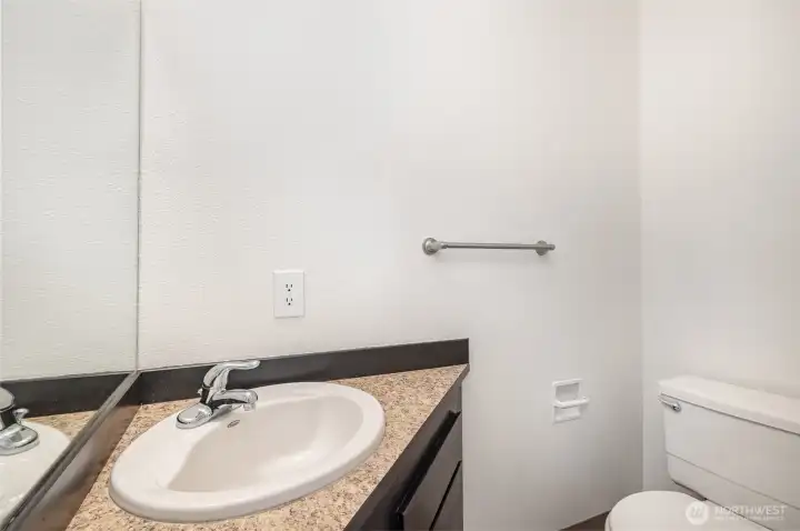 Hallway half bath for guests.