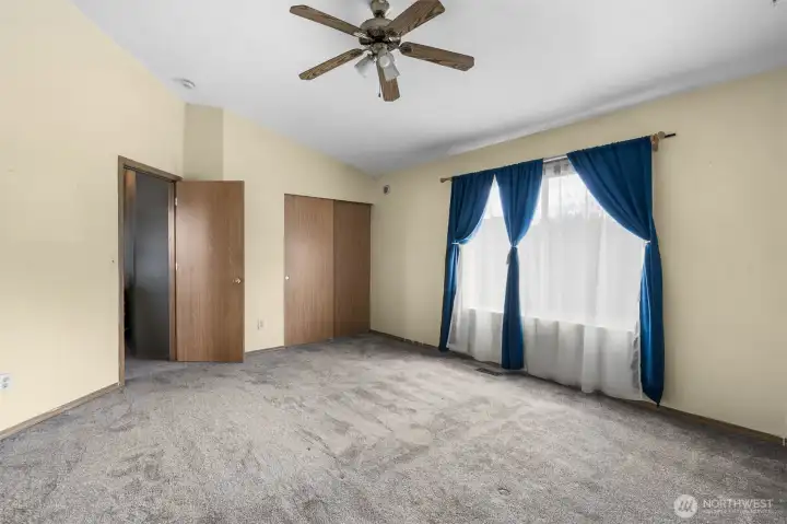 A spacious primary bedroom with room to relax and unwind