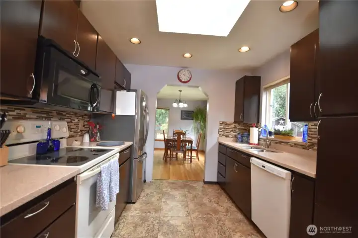 Bright and open kitchen w/granite countertops and stainless appliances. Lots of storage.