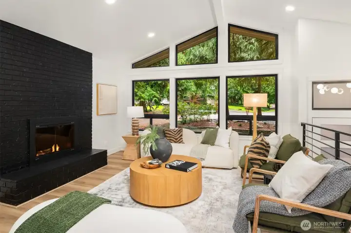 Floor to ceiling gas fireplace anchors the living space.