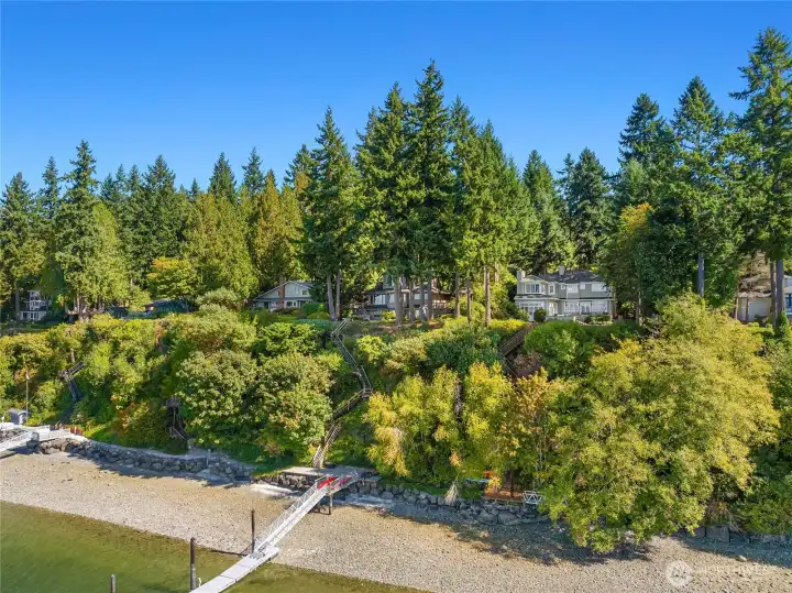 79 feet of fully bulkheaded mid-high bank waterfront, Deck atop the bulkhead with beach steps and a dropdown gangway for easy access to the walkable beach. Registered boat mooring buoy with anchor and chain replaced in March 2025