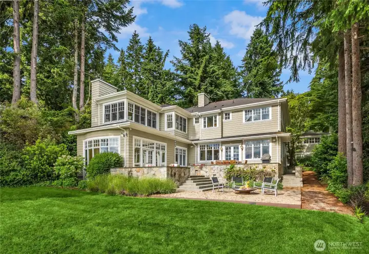 This west-facing waterfront home has sweeping views of the Olympic Mountains and  sunsets ablaze with color.
