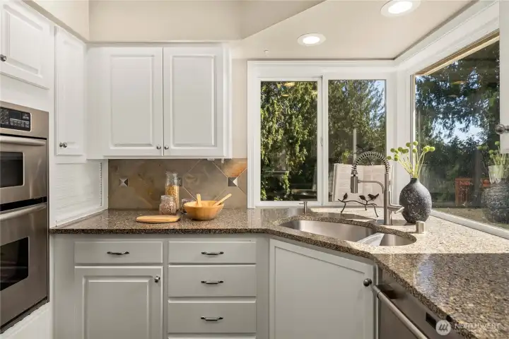 Granite counters with full-height backsplash.