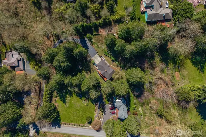 Tucked back on over an acre of lush evergreens.