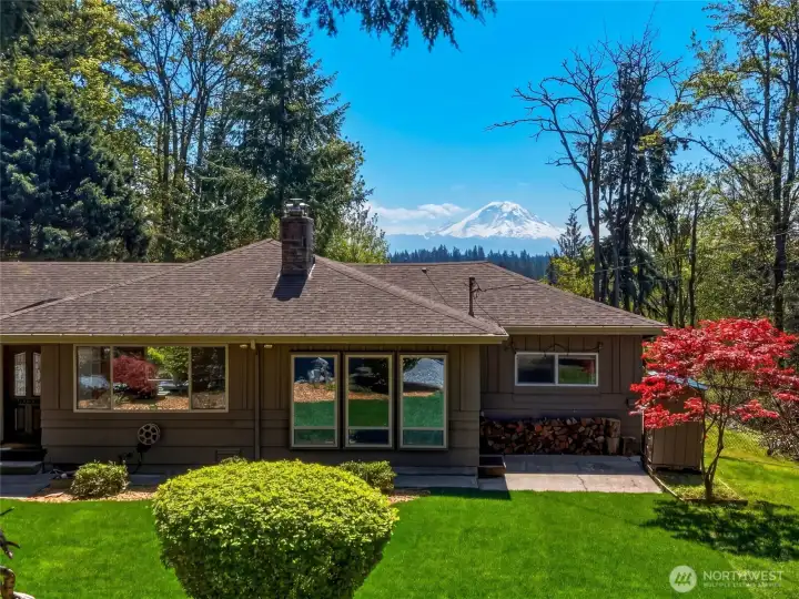 Charming single-story home with manicured front yard, lush greenery, and inviting curb appeal on a private 3-acre lot in Maple Valley