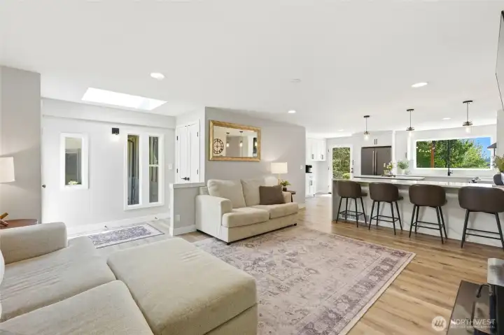 Spacious open-concept living area with large windows, fireplace, and comfortable layout designed for modern living.