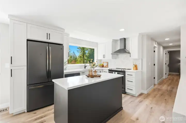 Spacious kitchen and dining area with island seating, perfect for entertaining and everyday functionality.