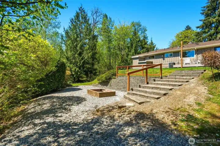 Terraced landscape with usable acreage, offering flexibility for gardening, hobbies, or expansion opportunities.