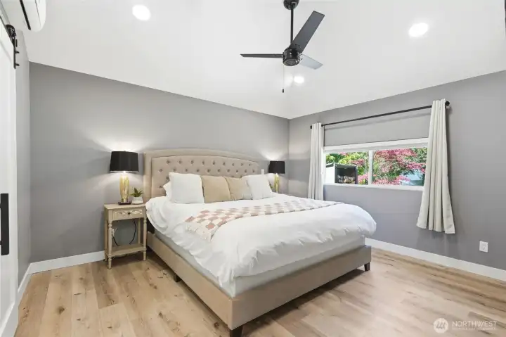 Bright and airy bedroom with updated flooring, neutral palette, and clean modern design.