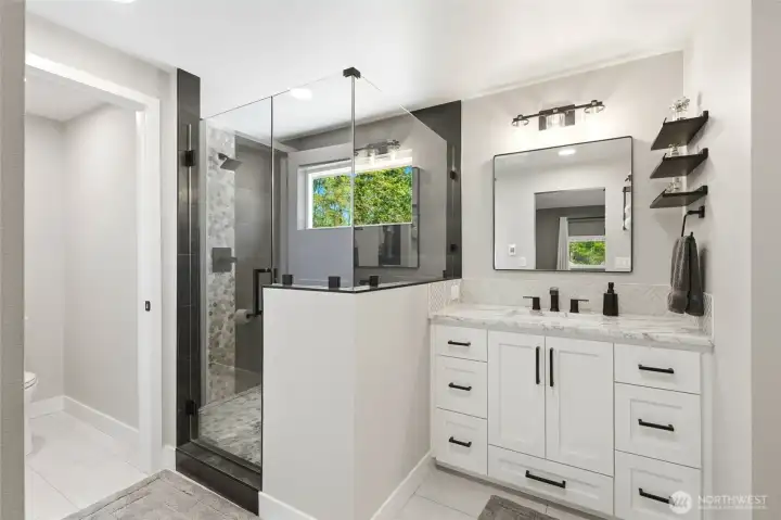 Fully updated bathroom with dual vanity, modern fixtures, and clean contemporary design in this Maple Valley acreage home.