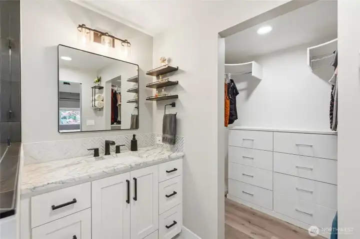 Remodeled bathroom with double sinks, ample storage, and upgraded lighting for modern functionality and style.