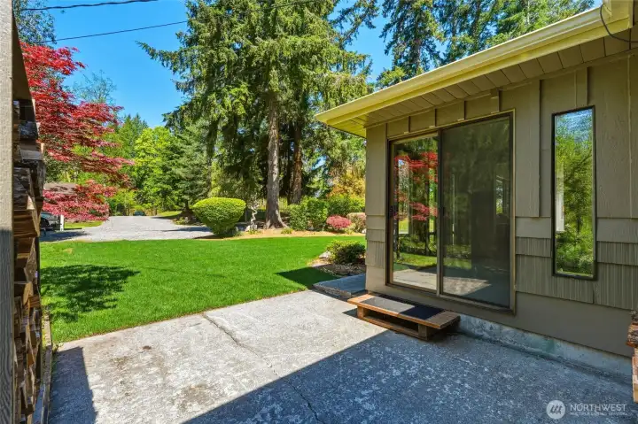 Back patio and exterior access showcasing seamless indoor-outdoor living on this private Maple Valley property.
