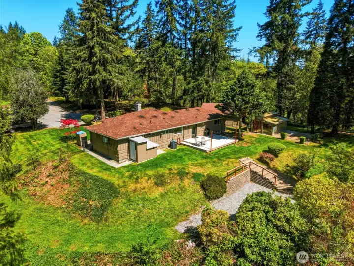 Aerial view of the home highlighting 3 acres of private land, mature trees, and peaceful natural surroundings.
