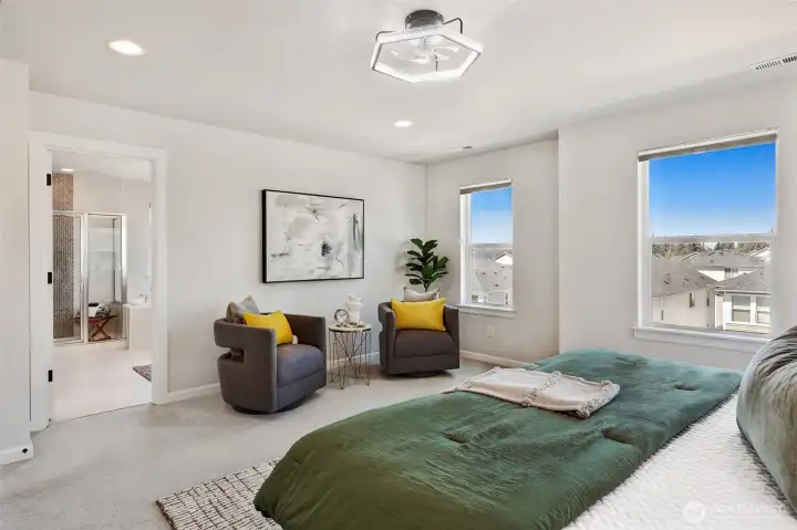 Primary bedroom with beautiful blue sky views with customs blinds in every room.