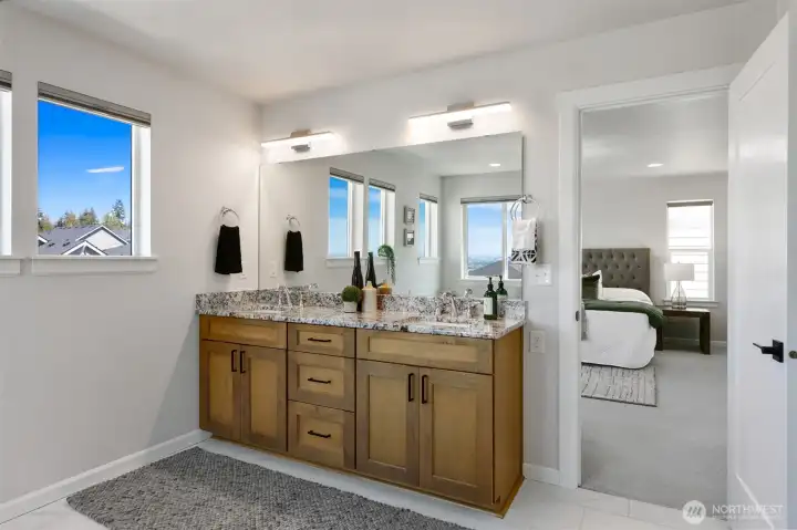 Primary bedroom featuring double sinks and extended height countertops