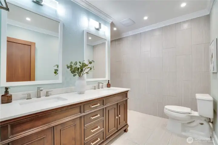 Double vanity. Custom millwork. The shower is just out of frame — and worth the wait.
