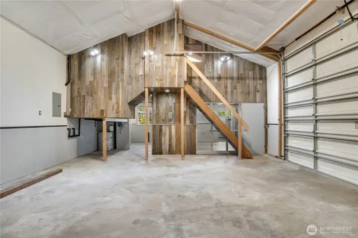 Floor to ridge. Reclaimed wood. Open loft. The panel is on the left. The staircase is straight ahead. Welcome to the shop.