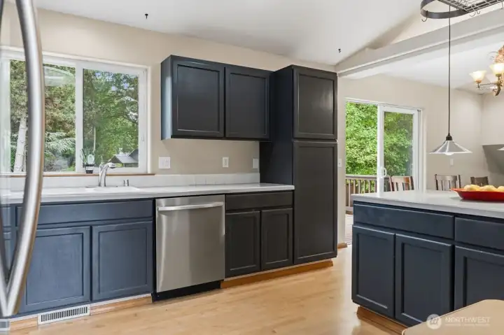 Another view of the kitchen, taken towards the patio door of the dining room. There are even more cabinets in the peninsula dining bar.