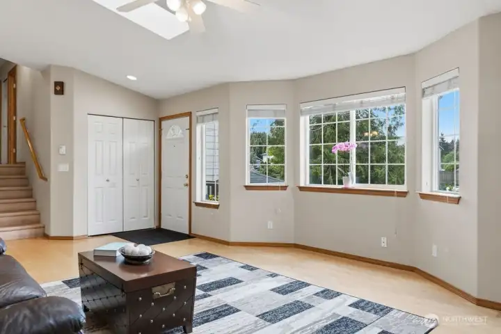The Living Room's bay window, skylights, ceiling fan and fireplace help to provide a bright and welcoming home.