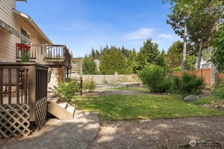 The back showing the upper deck, lower patio and back yard.