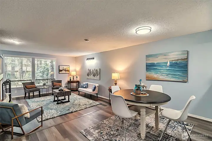Living and dining room. Updated engineered hardwood floors and new lighting.