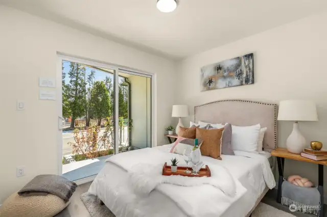 The large primary suite features a walk-in closet and sliding door to outdoor patio.